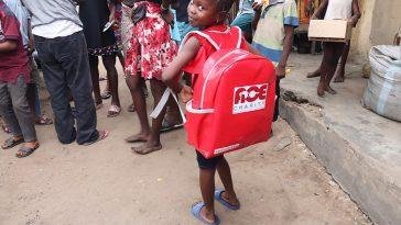 An excited Success Adegor showing off her ACE school bag which members of the Open Fees team presented to her when they visited her and her parents in Sapele last Weekend / Photo credit: Openfees.org