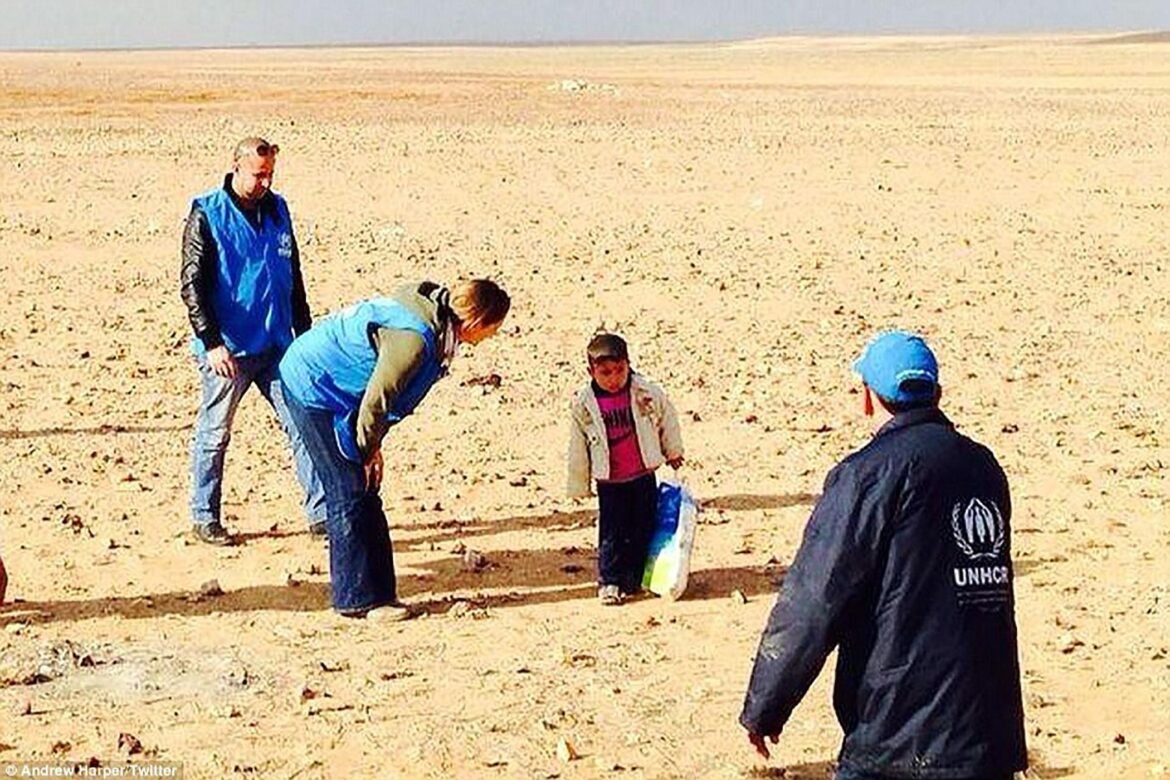 A file photo of four-year-old Syrian refugee Marwan being assisted by UNHCR officials / photo credit: dailymail.co.uk