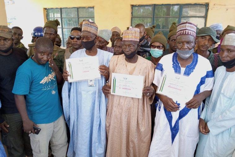 Some of the honoured hunters displaying their commendation certificates in Yola on Tuesday.