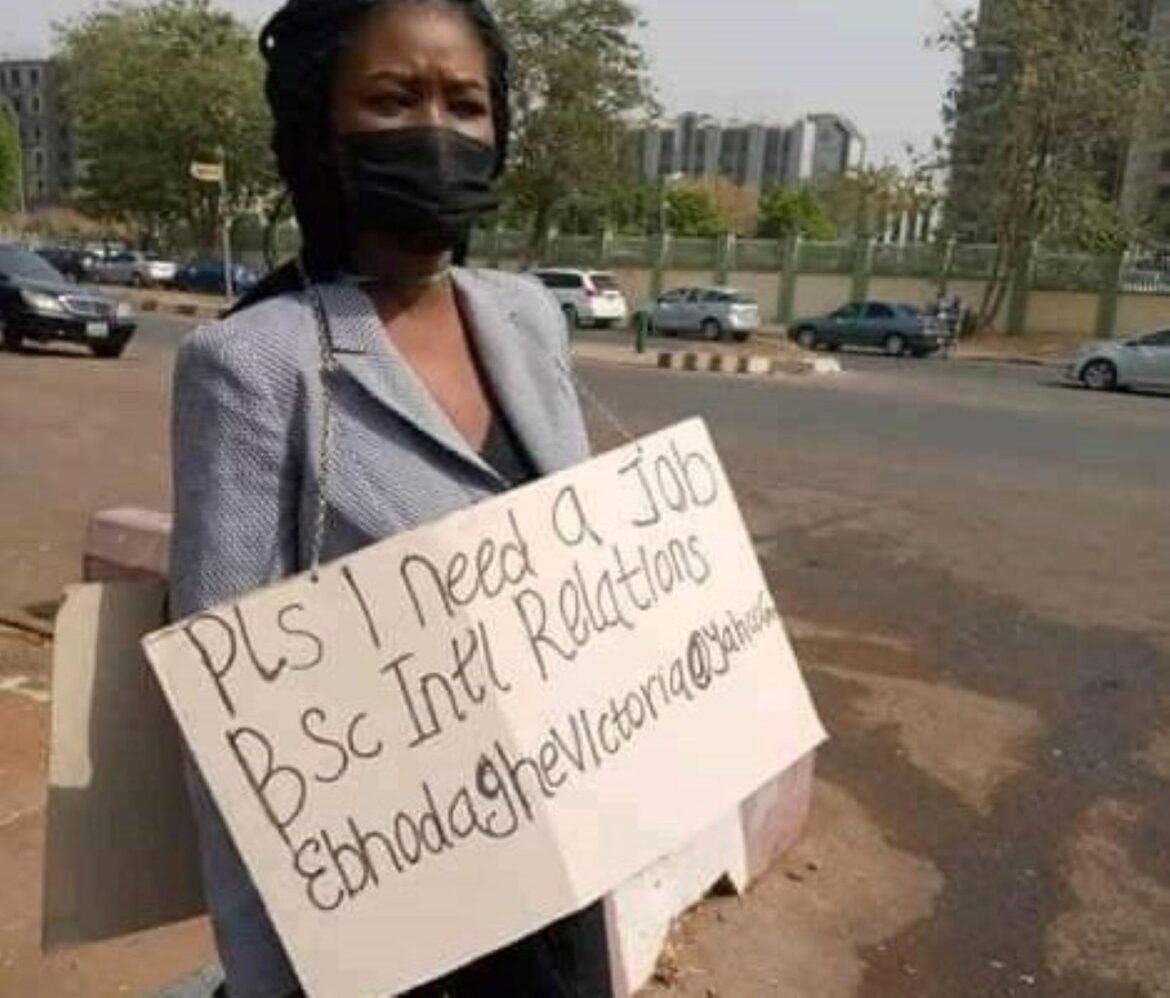 Victoria Edhaghe, with a placard on her chest boldly displaying her status as well as her contact details / Photo credit: Facebook