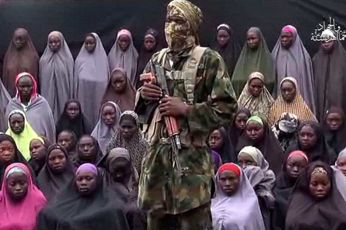 Some of the kidnapped Chibok girls with one of their abductors in a file photo taken years ago / Photo credit: ABC News