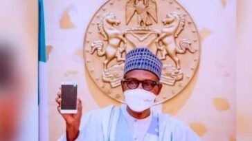 President Muhammadu holding the first Made In Nigeria cell phone / Photo credit: AIT