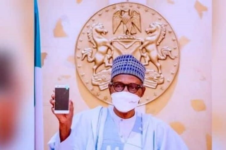 President Muhammadu holding the first Made In Nigeria cell phone / Photo credit: AIT